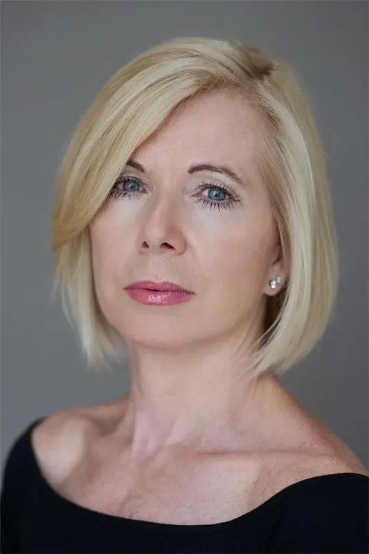 headshot of Joan dressed in black
