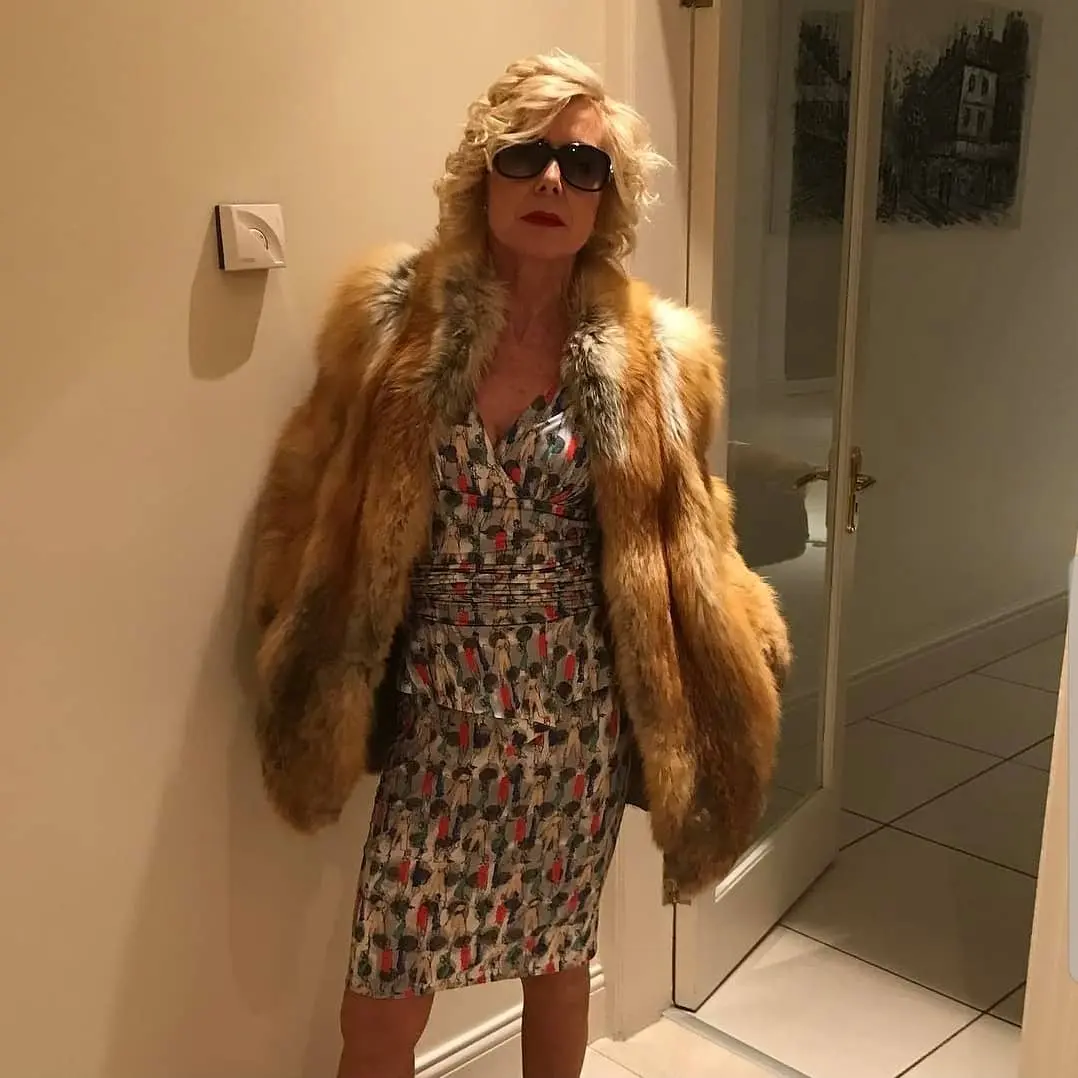 Joan dressed as her character Heather Jones with fur coat and sunglasses