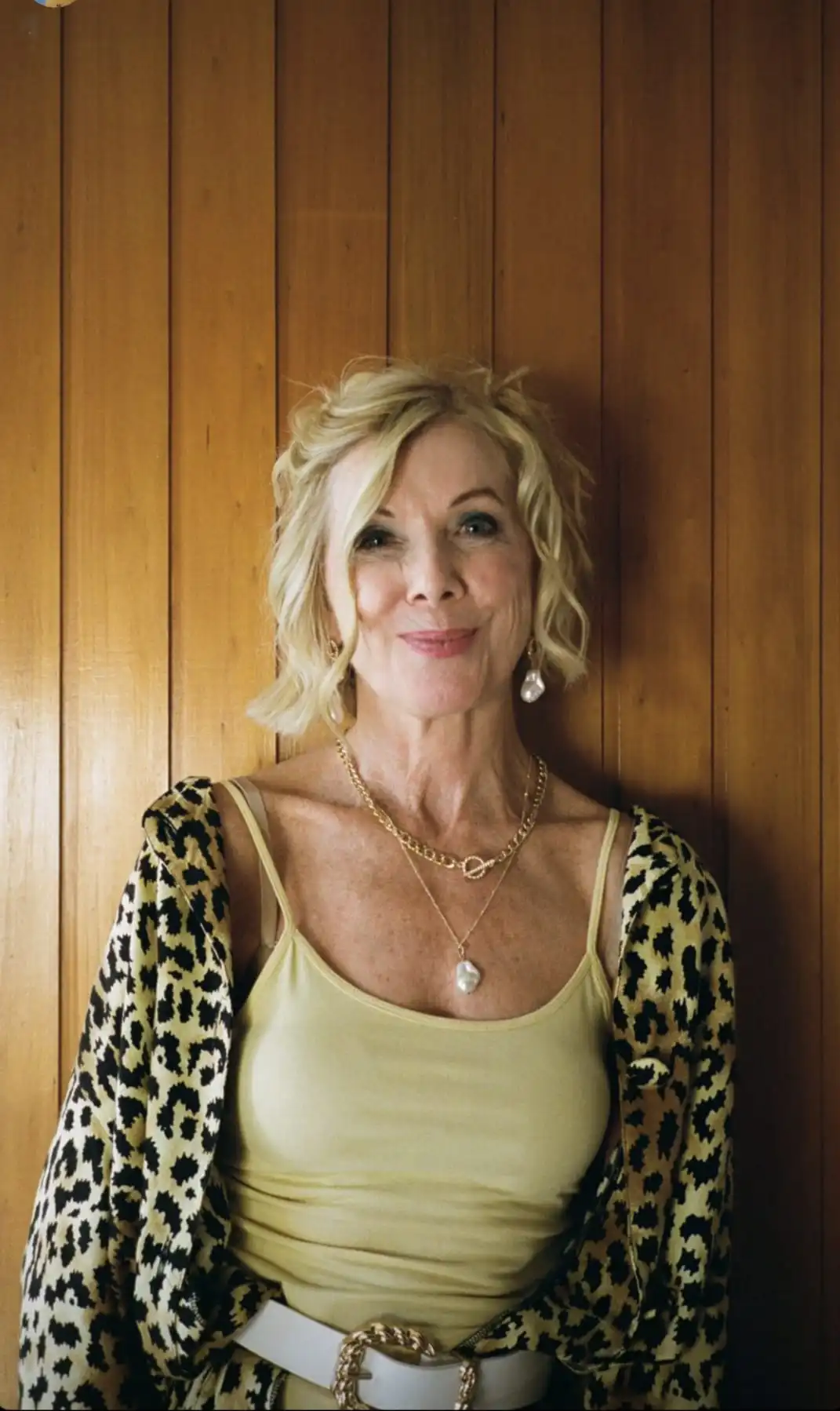 Joan in a leopard print outfit smiling at camera