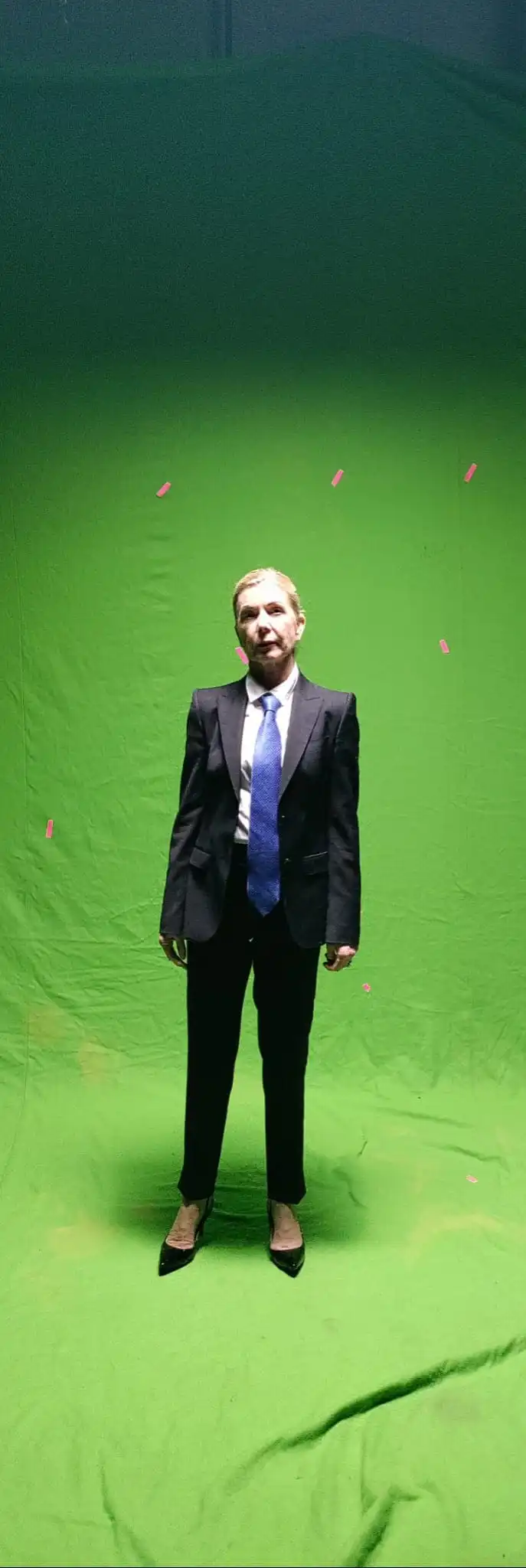 Joan in front of a green screen dressed as her Matriarch character